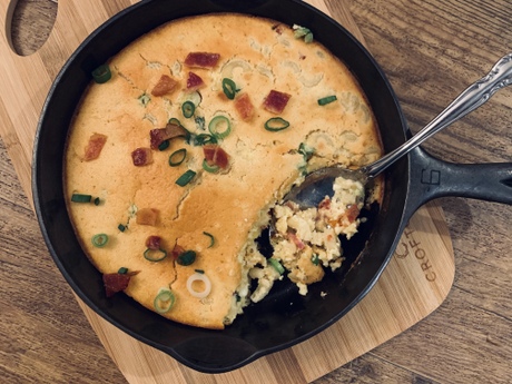 Mac and Cheese topped with cornbread made with organic eggs, baked in a cast iron skillet